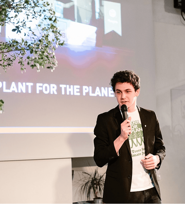 Ambassador presenting on stage by Plant-for-the-Planet.