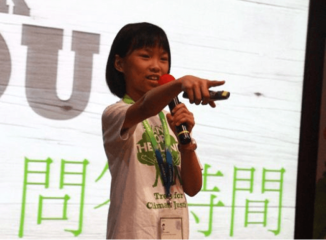 Girl speaking on stage with microphone by Plant-for-the-Planet.