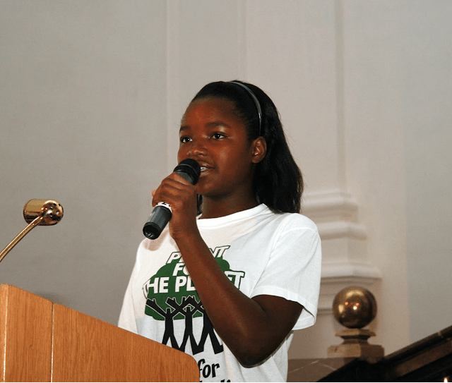 Young speaker giving a speech at podium by Plant-for-the-Planet.