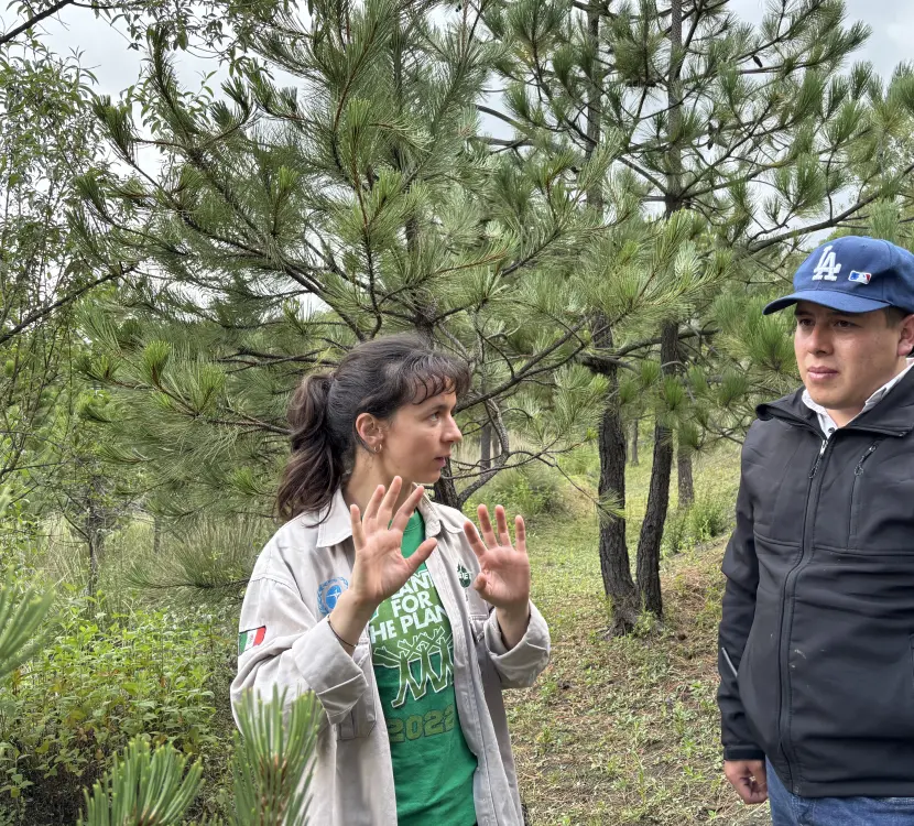 Anna dicussing with team member by Plant-for-the-Planet