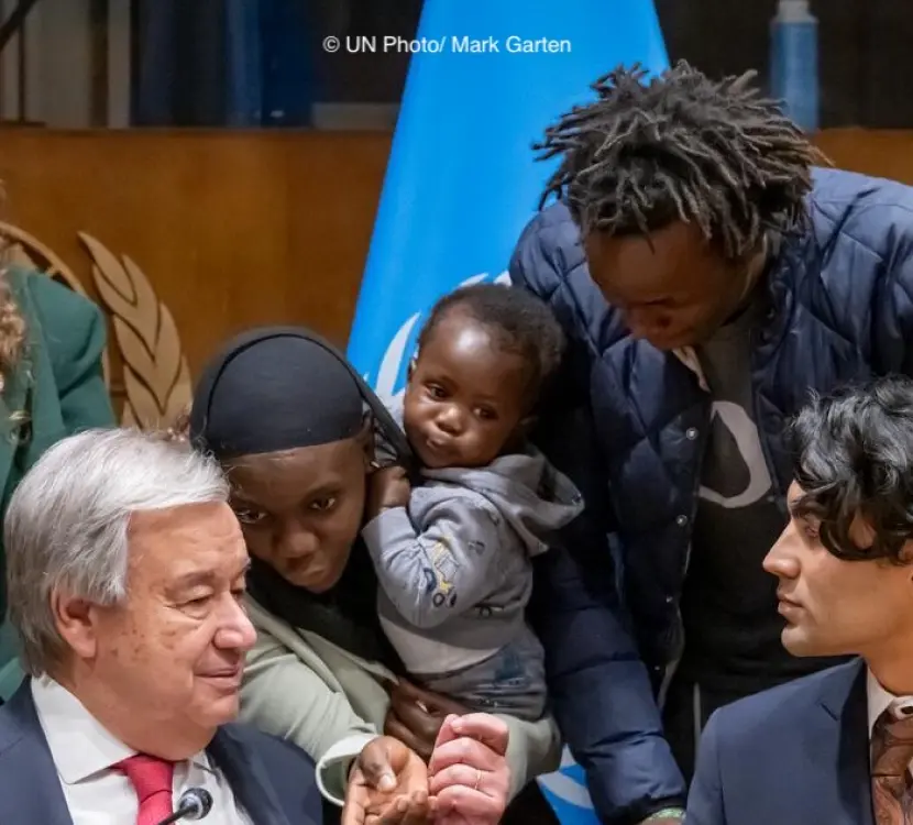 Fatou Jeng holding a child by Plant-for-the-Planet