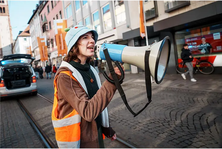 Climate activist speaking through megaphone by Plant-for-the-Planet