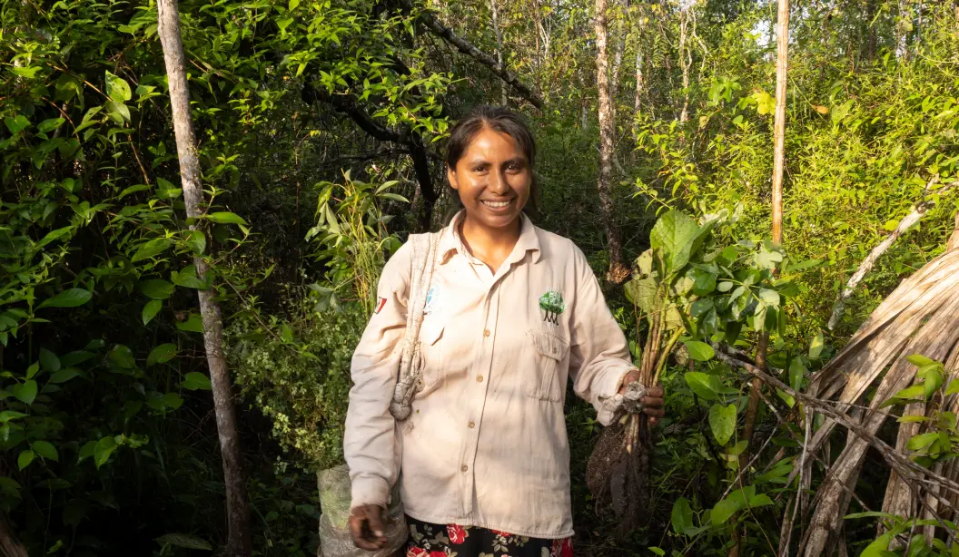 Restoration team member holding a Plant by Plant-for-the-Planet