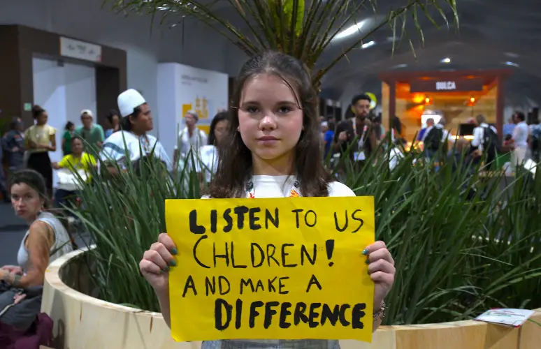 Young Ambassador holding a Poster by Plant-for-the-Planet